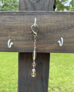 Handcrafted purse charm made with silver 16x30mm lobster clasp. Glass lamp work beads and round faceted glass beads. Drop length is 4 3/8 inches.