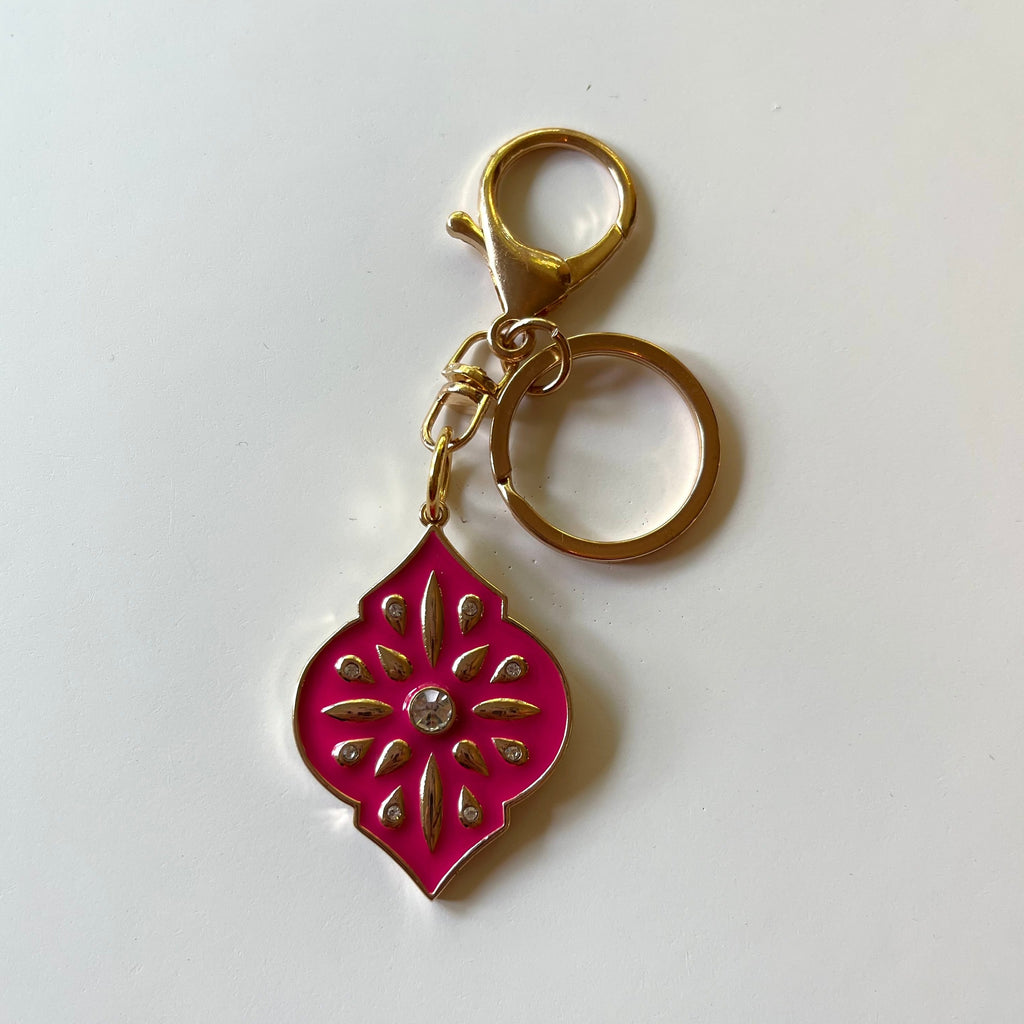 Handcrafted gold keychain. Gold pendant with enamel and rhinestones. 