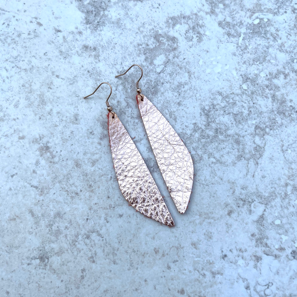 Handcrafted on rose gold stainless steel earring wires. Rose gold real suede leather cut in wings 3" x 3/4".