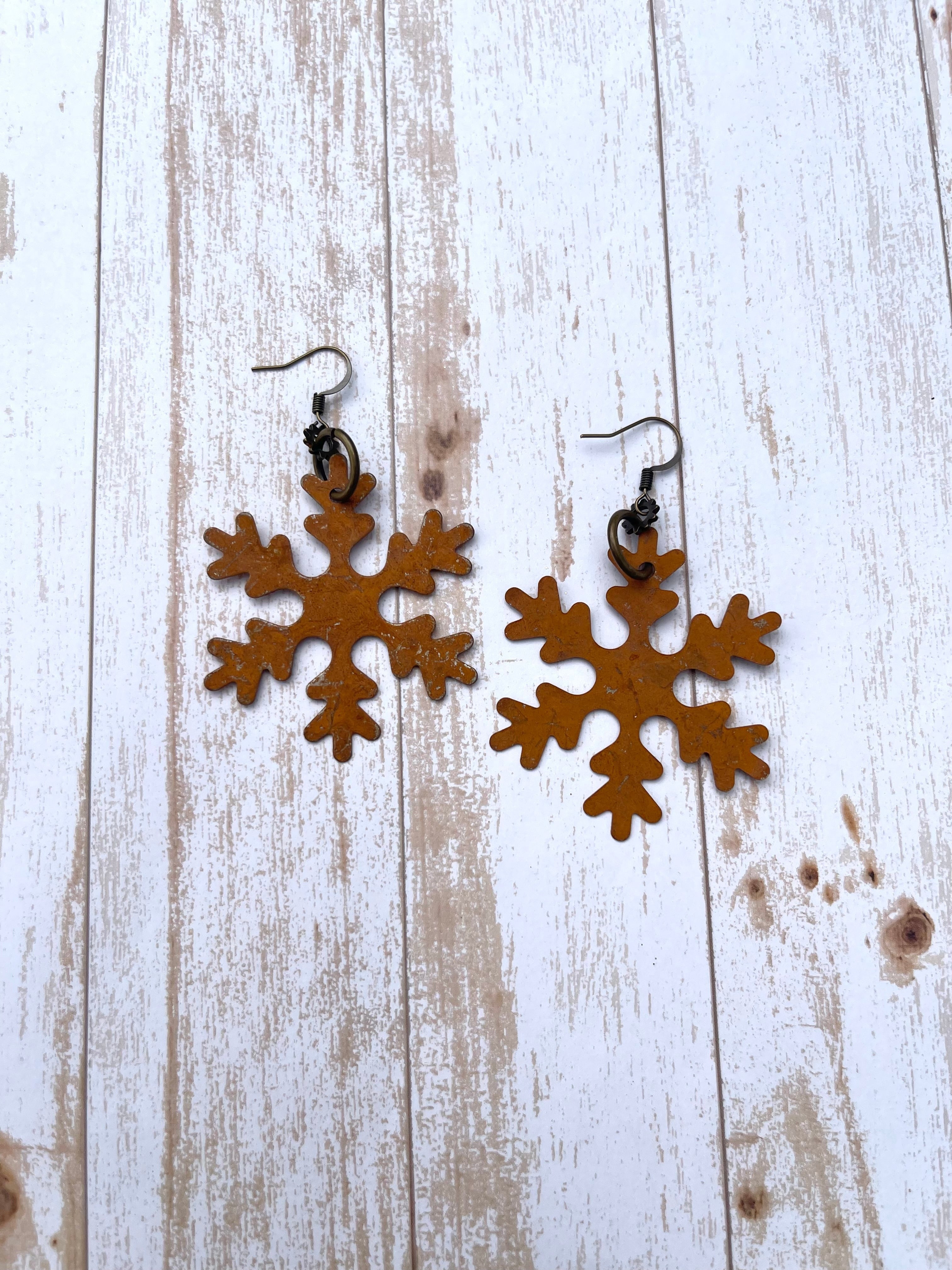 Handcrafted on brass earring wires. Metal snowflakes.