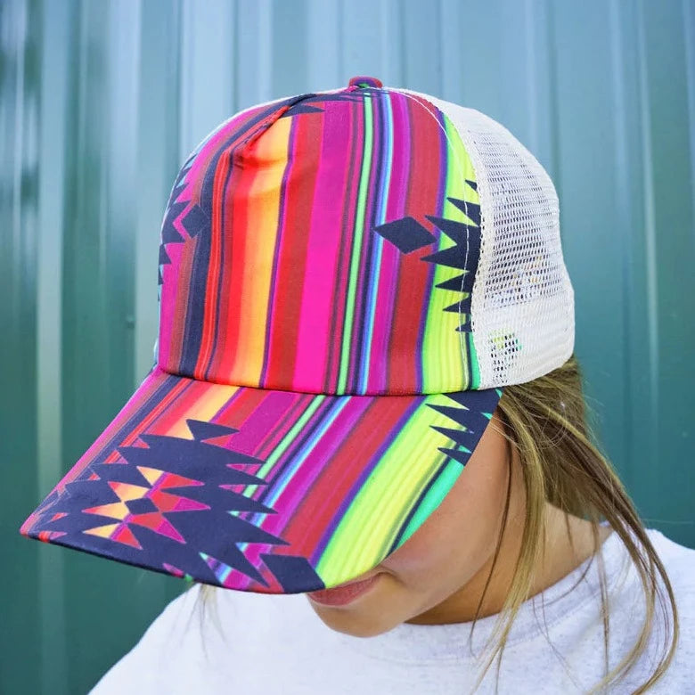 Serape Ponytail Cap. 65% Cotton, 35% Polyester. Beige Mesh Back. Slot with Criss-Crossing Elastic Bands in Back for High Ponytail or Bun. 7 Panel - 2 Solid, 4 Mesh, and 1 with Straps and Closure. Adjustable Velcro Closure. Pre-Curved Visor. Adjustable, One Size Fits Most.