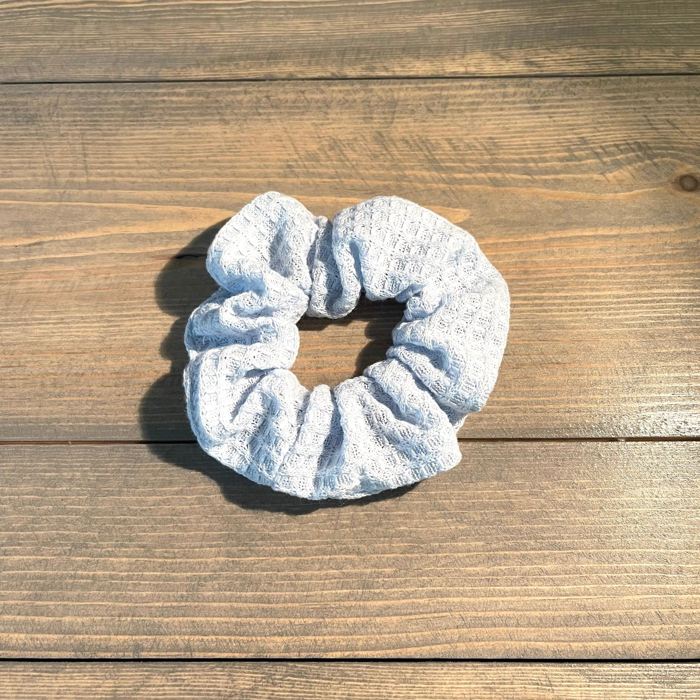 Cotton textured hair scrunchie is pale blue.