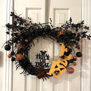 Handcrafted spider wreath on a grapevine wreath base. Wooden "eek" word, florals, and lots of spiders.