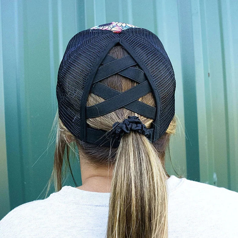 Sunflower prism ponytail cap. 65% Cotton, 35% Polyester. Print front. Black mesh back. Slot with criss-crossing elastic bands in back for high ponytail or bun. 7 panel - 2 solid, 4 mesh, and 1 with straps and closure. Adjustable velcro closure. Button top. Pre-curved visor. Adjustable, One Size Fits Most.