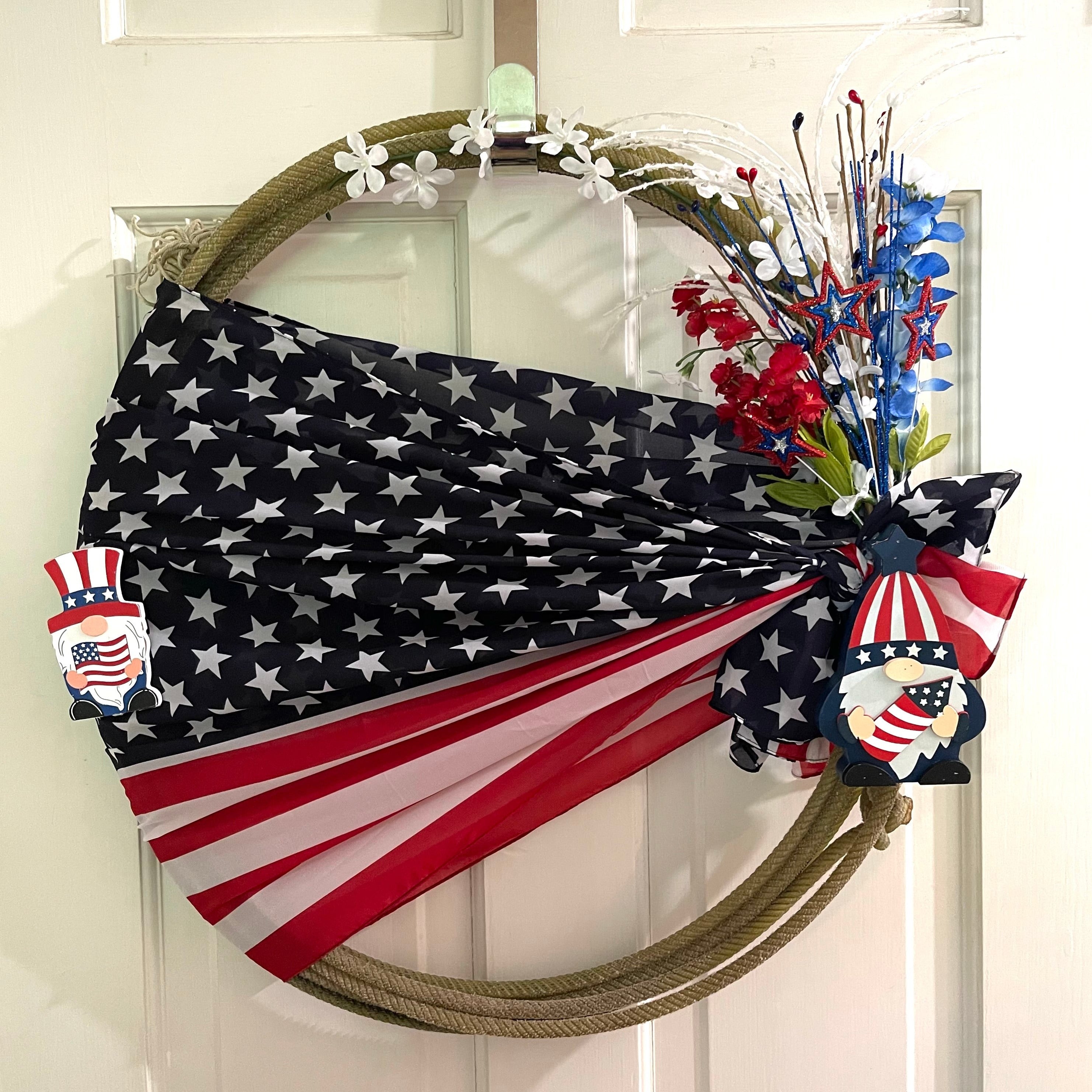 Handcrafted wreath on an upcycled lariat roping rope. Width: Approximately 20 inches. Florals and patriotic decorations. 