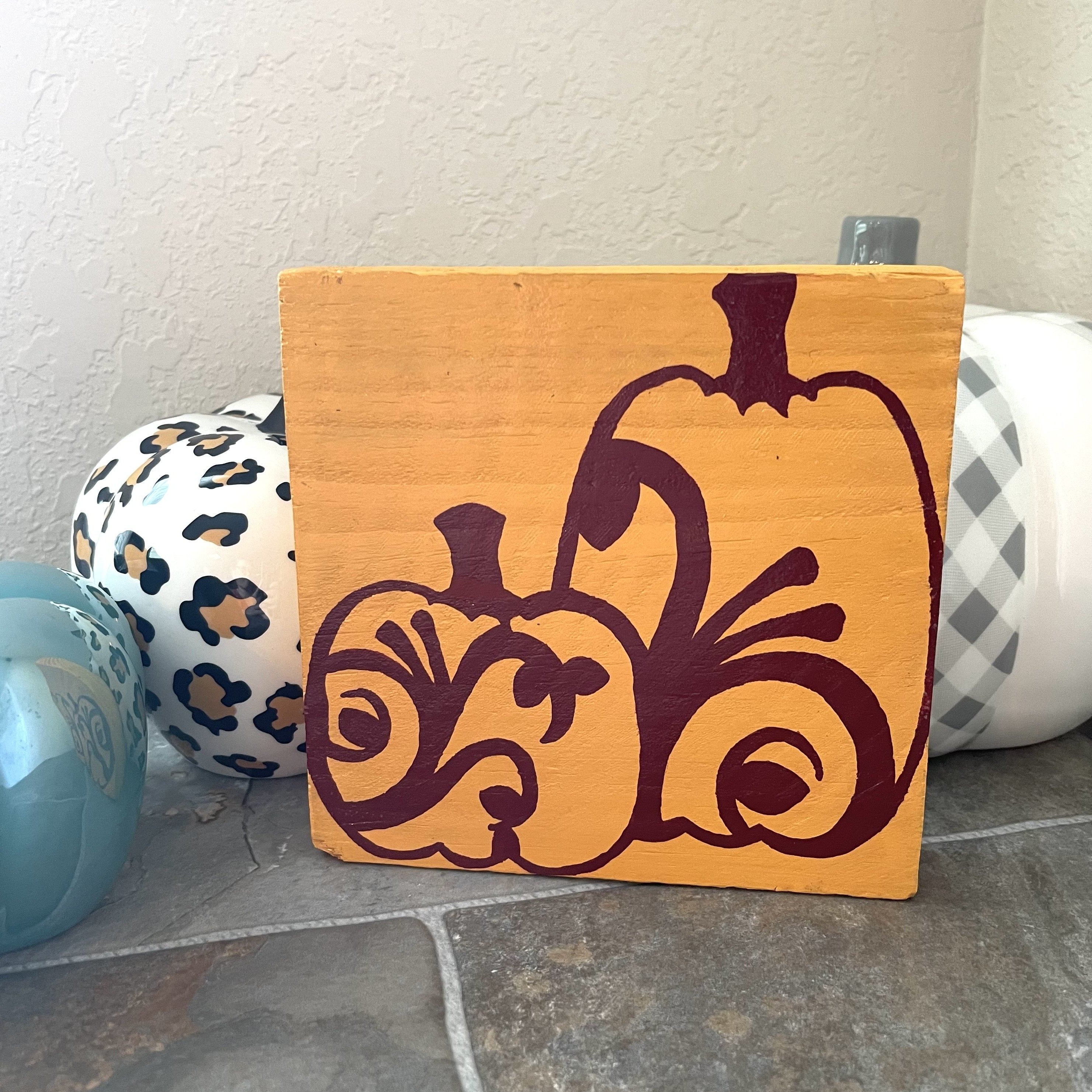 Hand painted light orange and burgundy. Board measures approximately 6x6 inches.  Board is also 1 inch thick.