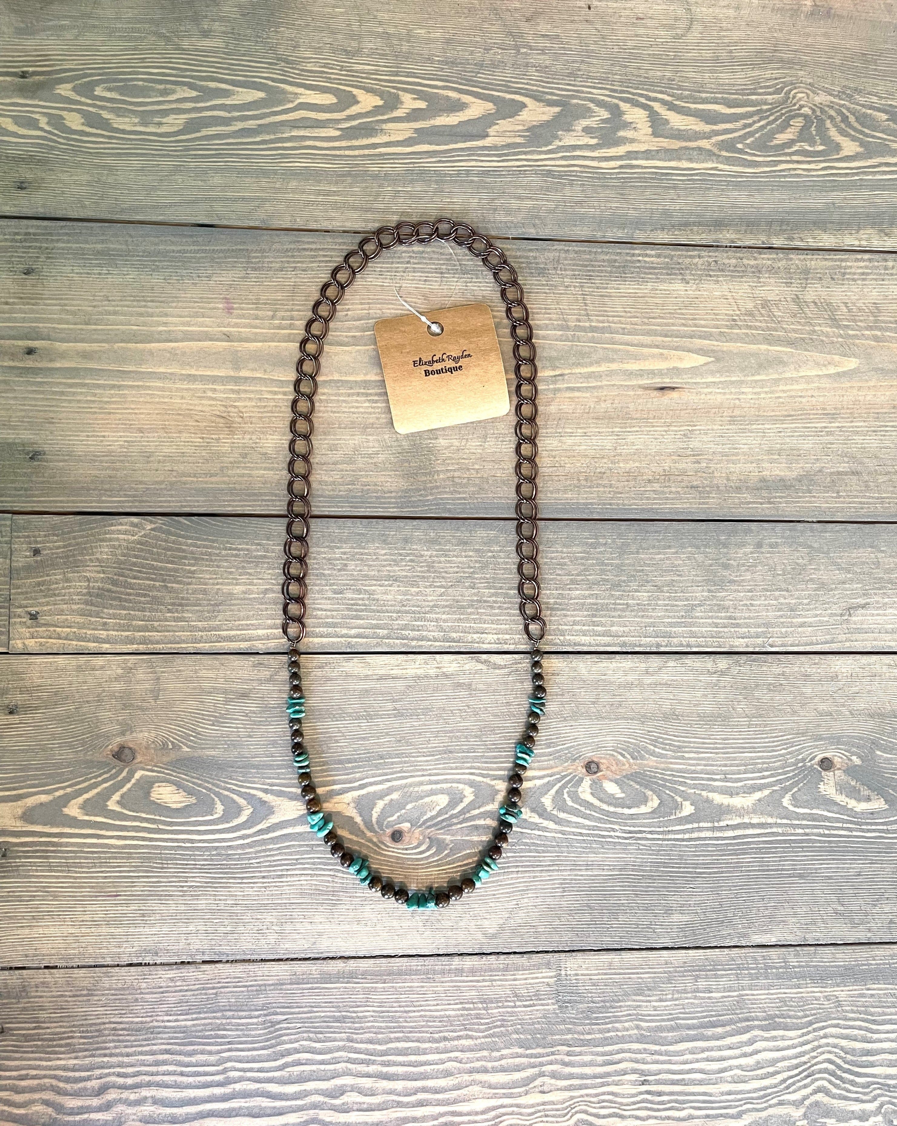 Handcrafted and designed. 5-8mm natural turquoise chip beads. 6mm bronzite beads. Double link chocolate chain. No clasp, just slips over your head. Approximately 29 1/2 inches in length.