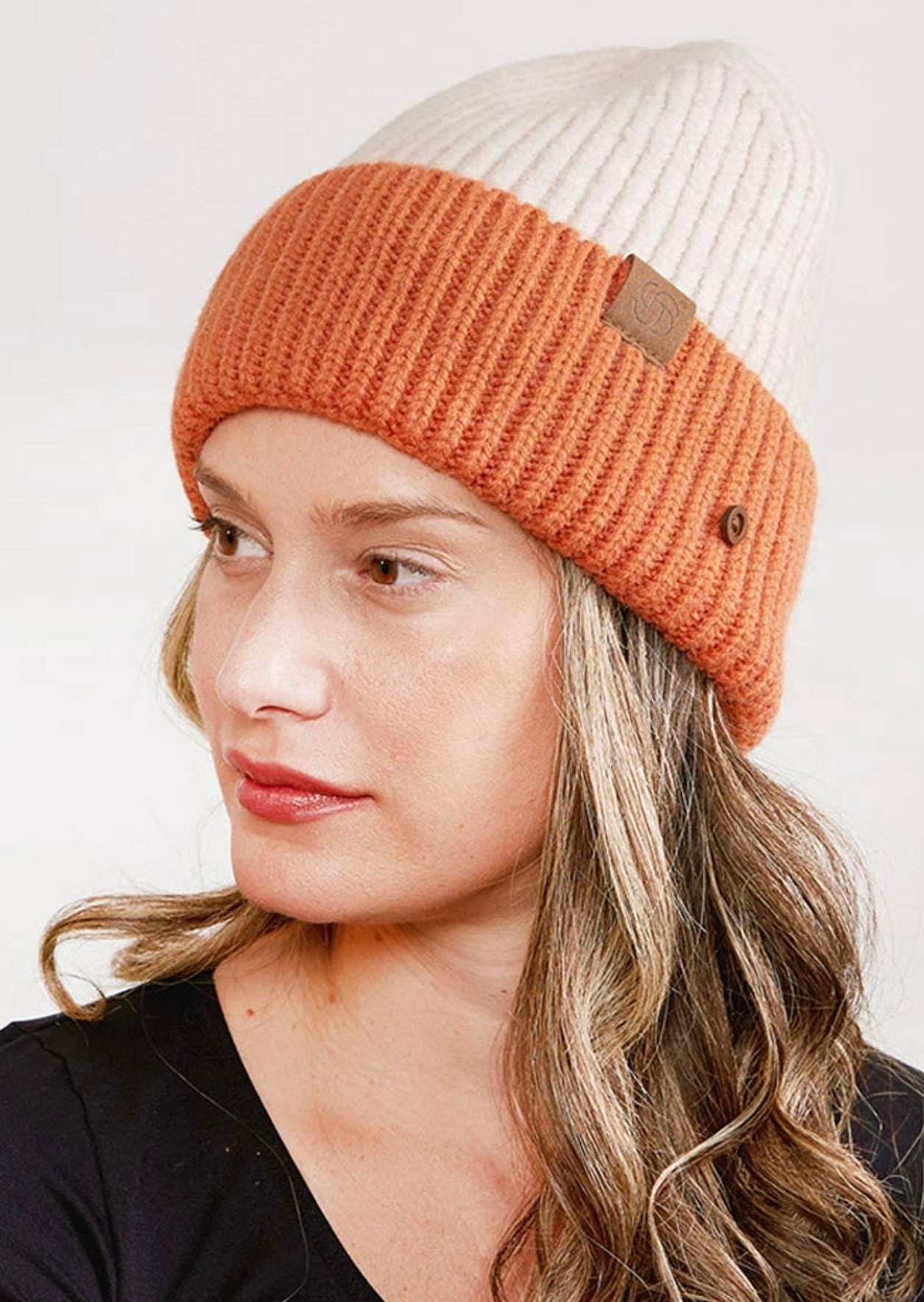 Beige/Blush beanie. 100% Acrylic. Knit ribbed brim beanie with buttons.