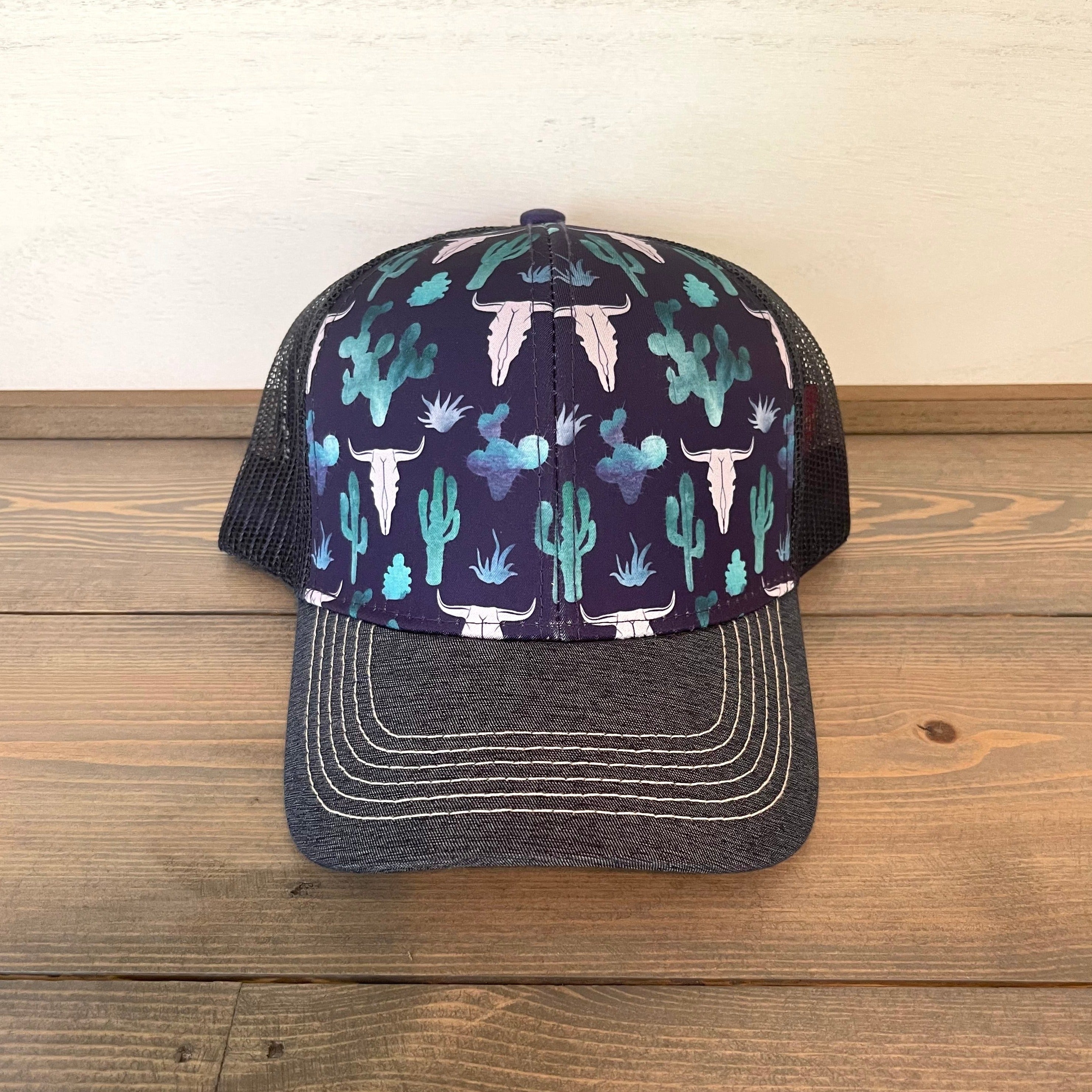 Women's Farm Girl skull cactus cap. One size fits most. Mesh back. Adjustable snapback closure. Blue, green, and white.