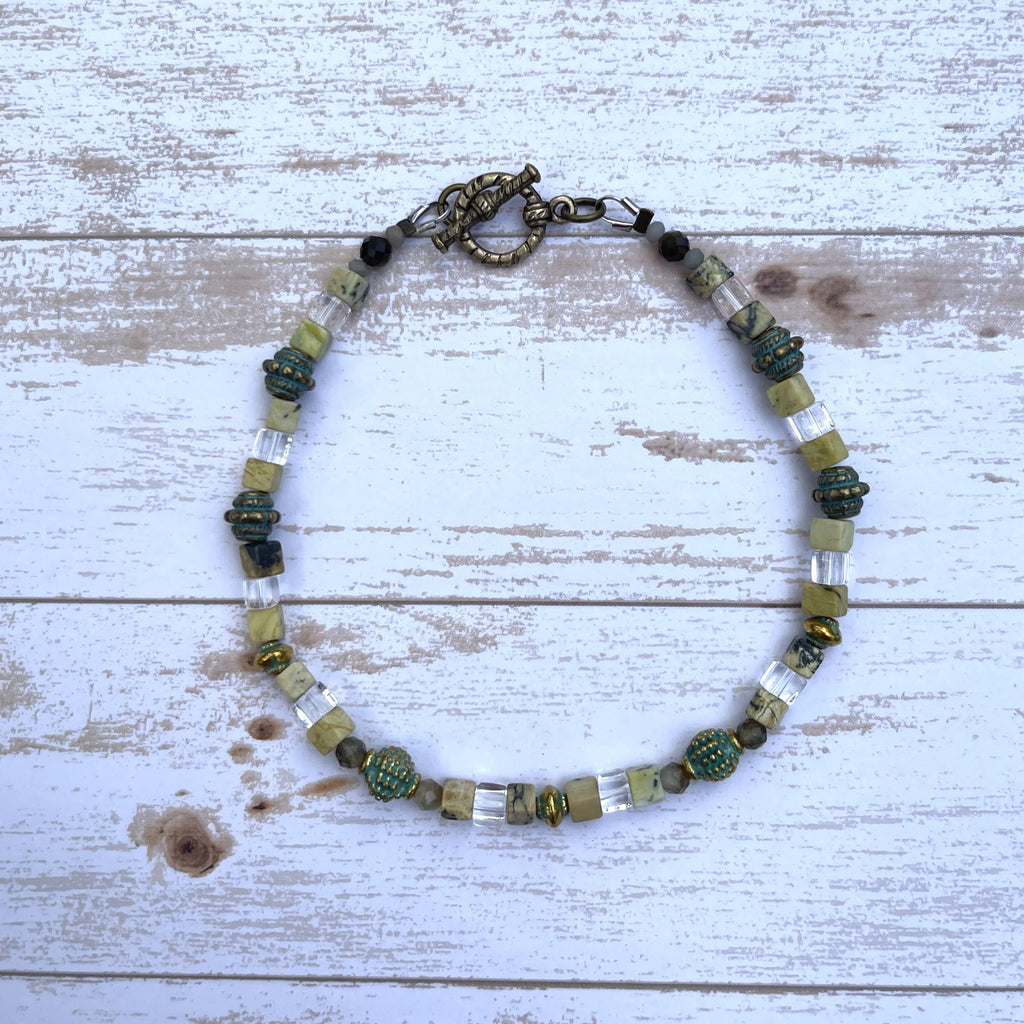 Handcrafted anklet on thermally bonded bead weaving thread with brass toggle. Beaded with yellow turquoise cubes, clear glass cubes, brass beads, gold labradorite, golden sheen obsidian, and tiny crystal rondelles.