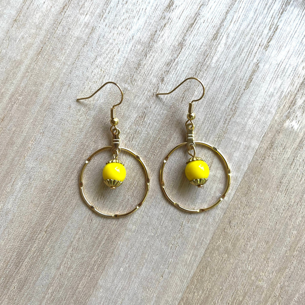 Handcrafted earrings with 18K gold plated wires and components. Glass yellow bead.