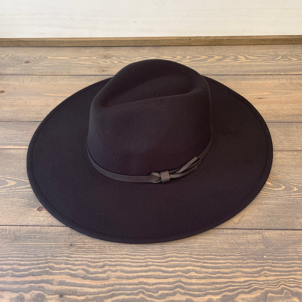 Felt wide brim fedora hat featuring solid leather band. 100% polyester. Adjustable drawstring inside hat. One size fits most. Hat circumference: 22.5" Brim width: 4" Color: Black.