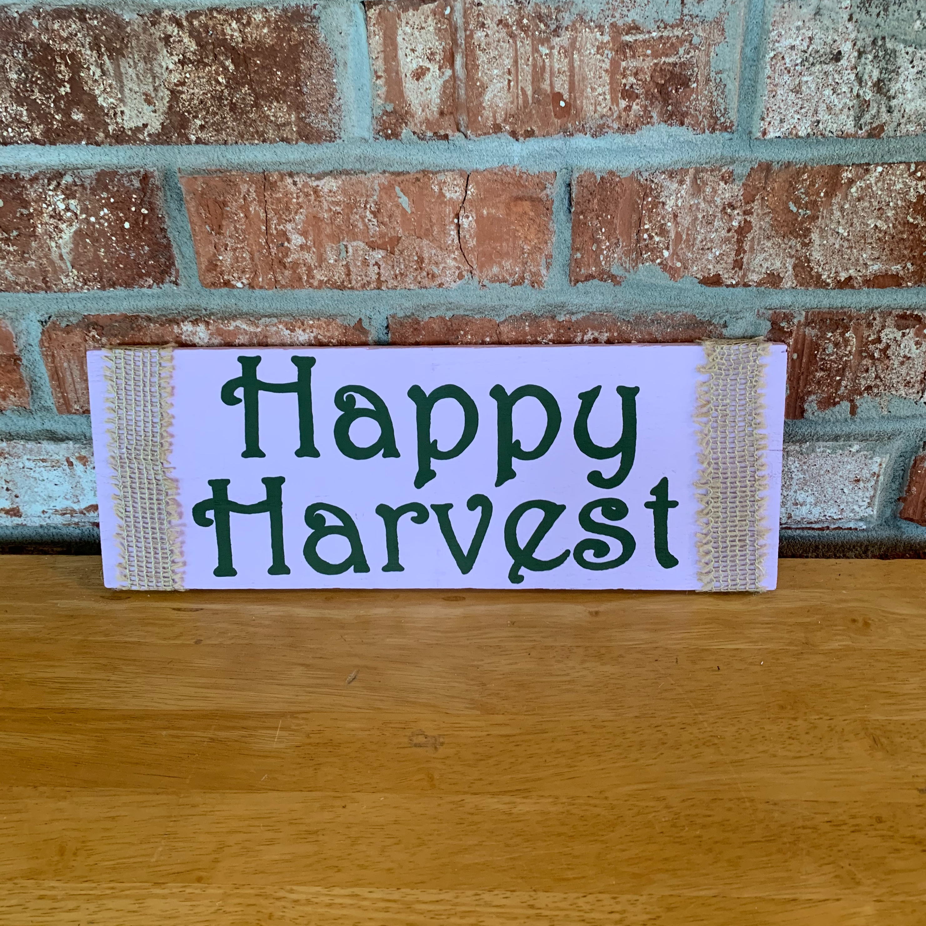 Sign is hand painted lavender and ivy green. Sign is wrapped in burlap ribbon and has a rope to hang it.  Sign measurements are approximately 15x5 1/2 inches.