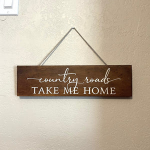 Handcrafted wooden sign with a linen braided cord for hanging. Length is 14.5 inches. Painted  lettering, stained, and sealed.