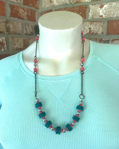 Handcrafted necklace made with all antique brass. Necklace is 30 1/2 inches long with 3 1/4inch extender. Coral dyed hematite disk, turquoise wooden disk, and 8 mm round silver hematite stone beads.