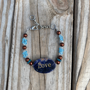 Handcrafted with stainless steel and silver chain and findings.  Nickle free. Beaded with swarovski crystals, glass pearls, rhinestone spacers and a lapis stone centerpiece. 