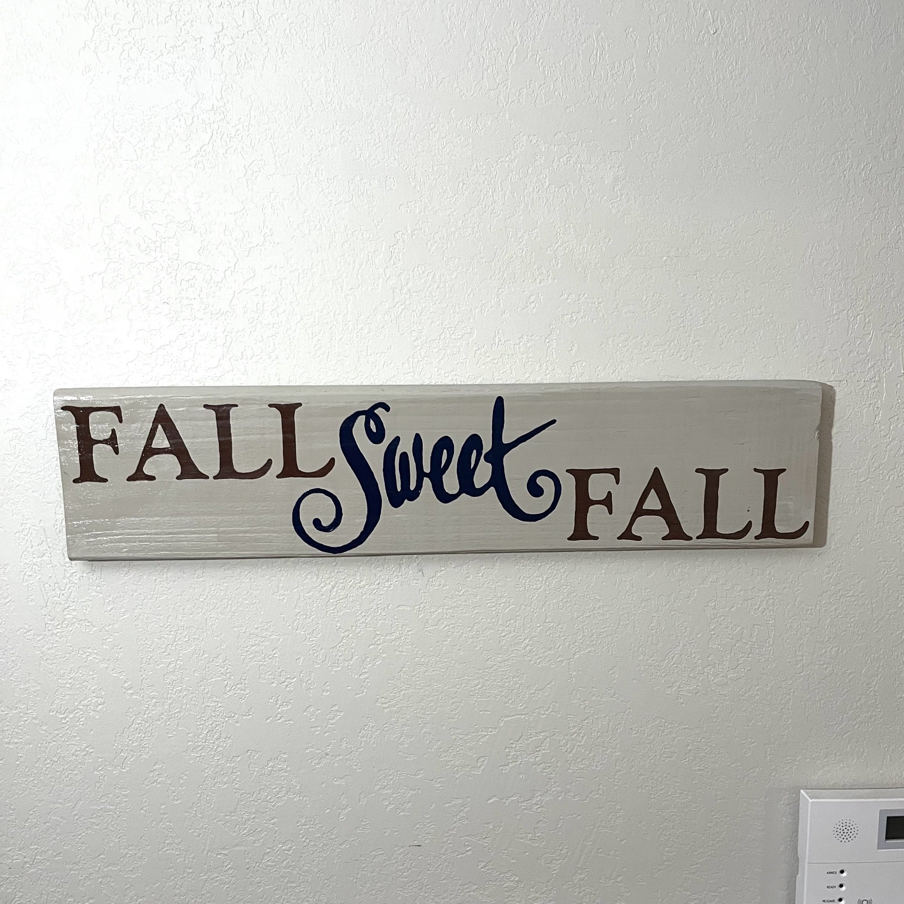 Hand painted cream, brown, and navy. Sign can be hung or even used as a leaner. Sign measures 24 1/8 x 5 1/4 inches.