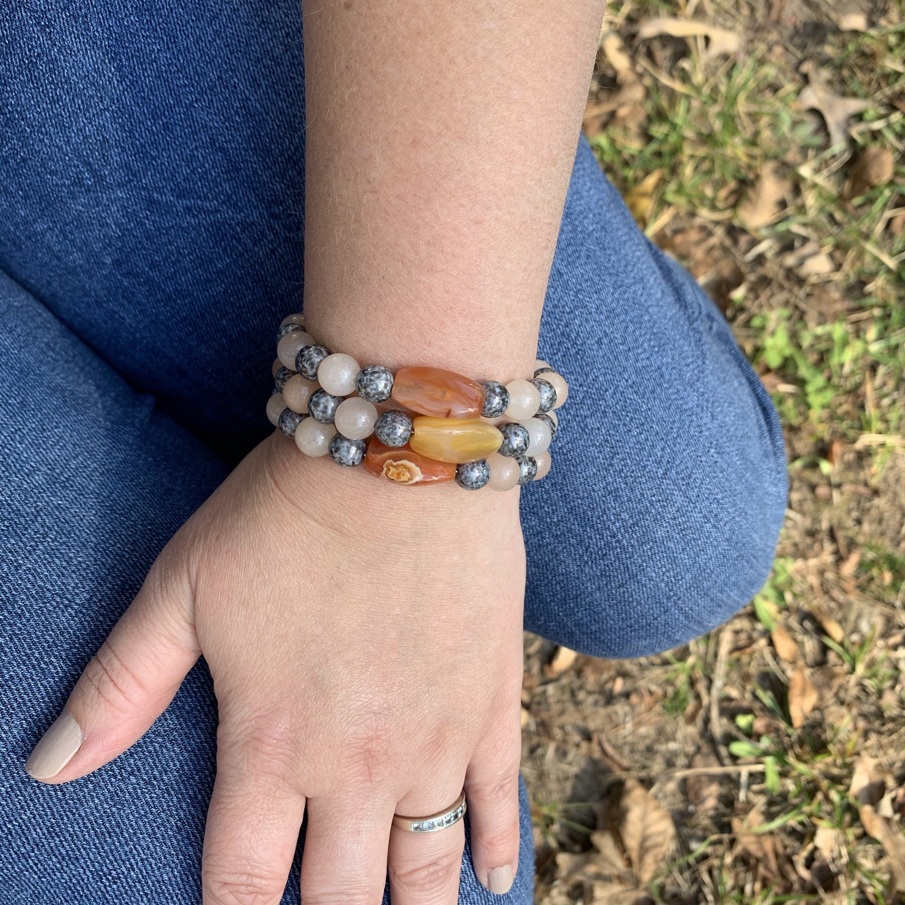 Hand crafted bracelet made on memory wire. Beaded with rose quartz, carnelian nuggets, and grey luster glass bead