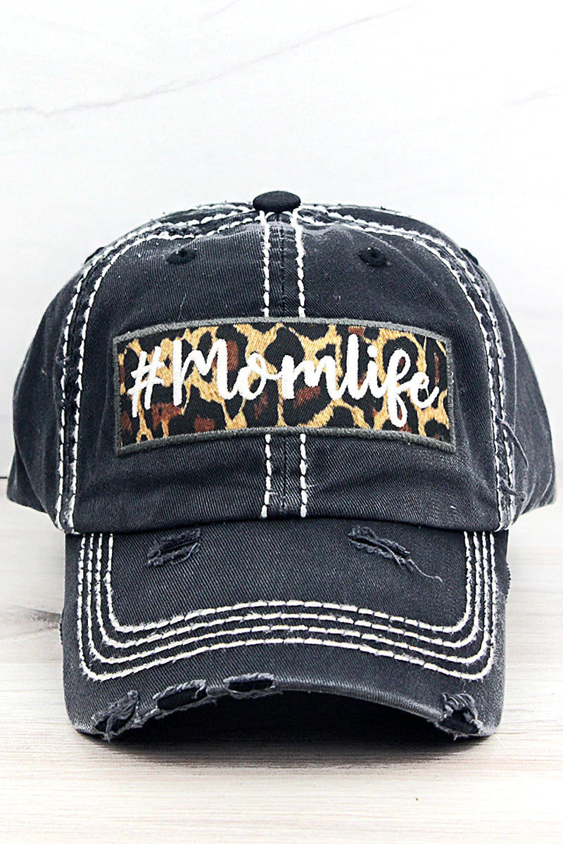 Distressed hat with a patch. Underneath the bill of the hat is also leopard print.  Adjustable Velcro Closure. 100% Cotton.