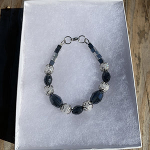 Handcrafted with Montana blue glass rice beads, crackle quartz, and hematite cubes.  All metal is stainless steel. Bracelet is 7 1/2 inches long.