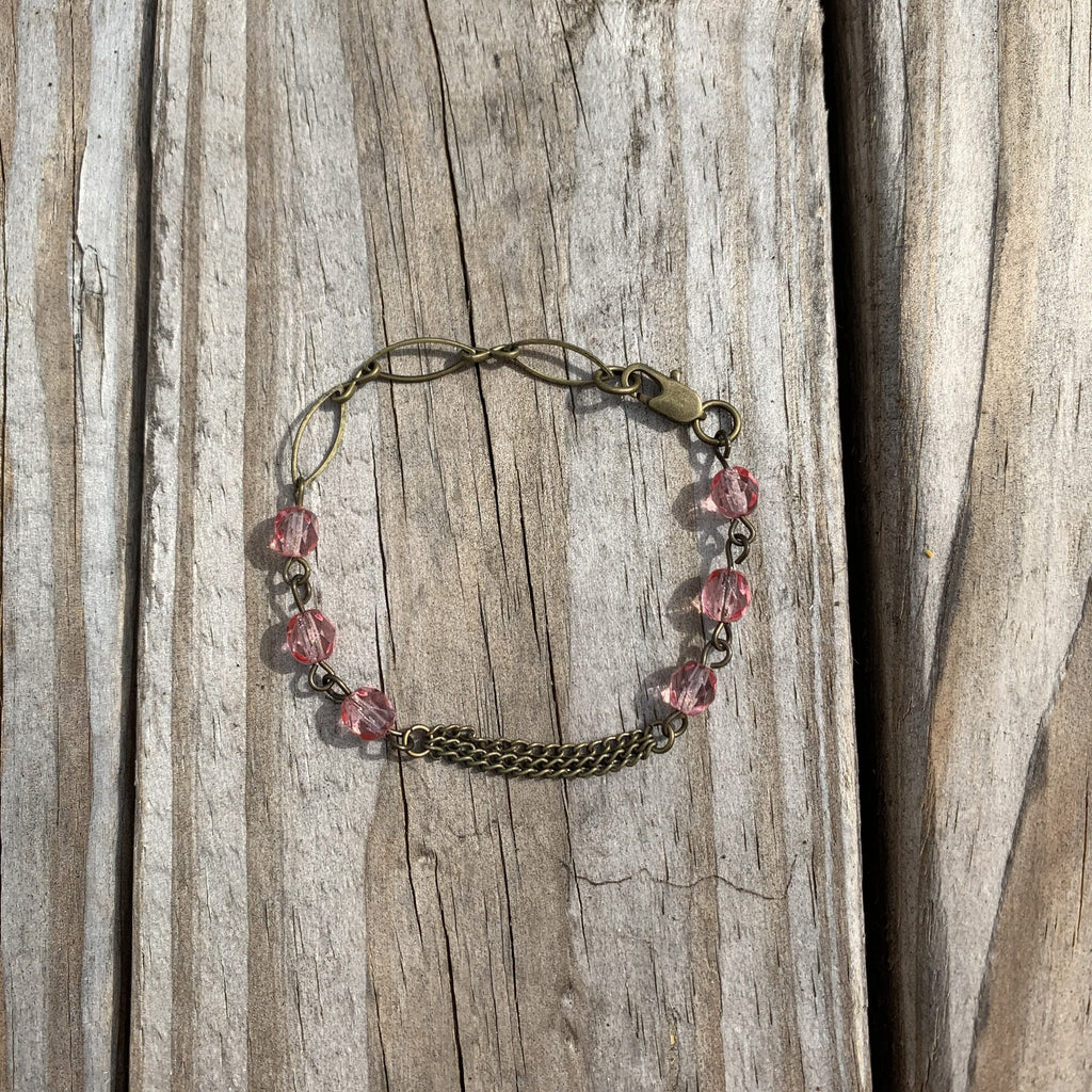 Handcrafted with all brass. Pink glass faceted beads. Bracelet is 7 inches long.