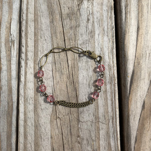 Handcrafted with all brass. Pink glass faceted beads. Bracelet is 7 inches long.